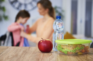 Healthy school lunch box with sandwich and fresh vegetables