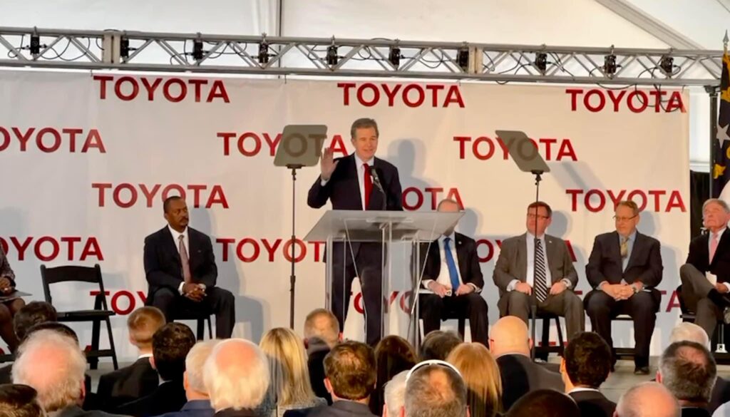 Gov. Roy Cooper, flanked by other state leaders, speaks at the announcement event for Toyota Motor North America bringing 1,750 jobs to Randolph County (PJ Ward-Brown|The North State Journal)